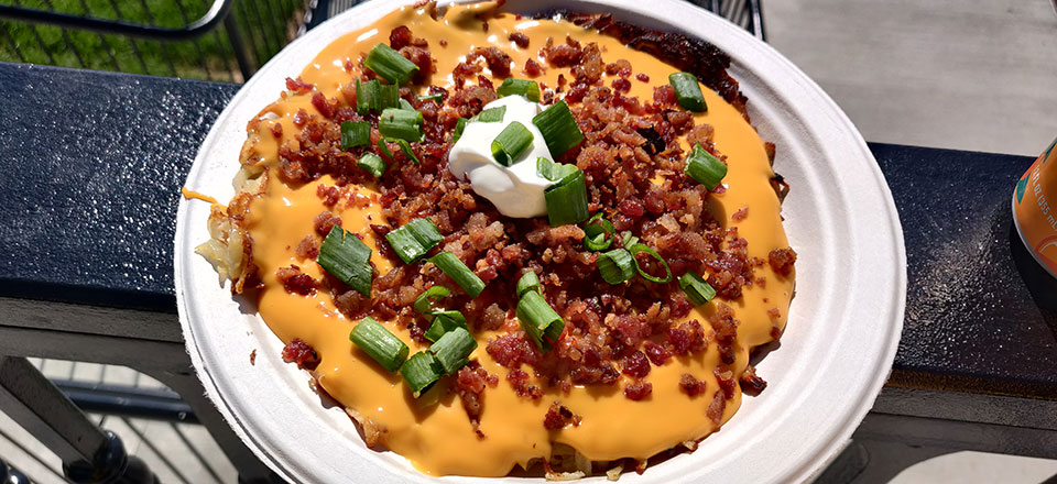 a latke the size of a dinner plate, covered with loaded baked potato toppings (so you know it's not kosher)